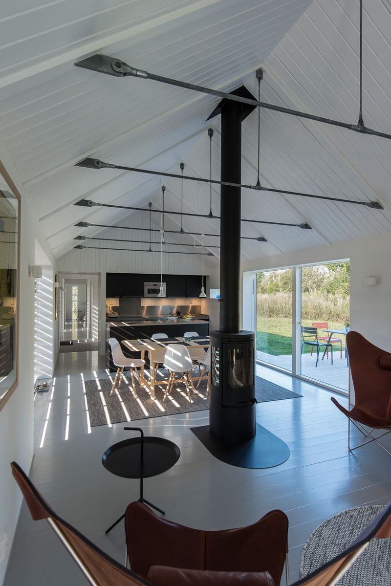 A black fireplace and matching black kitchen cabinets bring contrast and a modern edge to the shared living space.