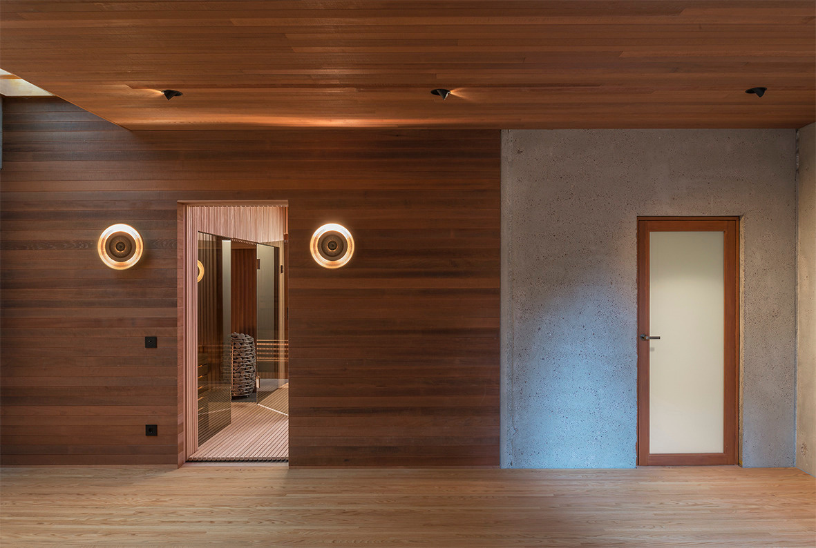 The doors to the sauna and bathroom in this mid-century modern inspired home reflect the design found inside.