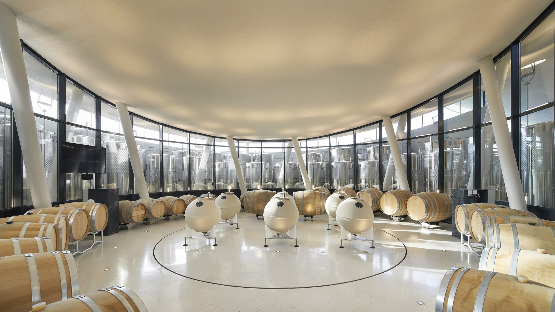 Underground fermentation, bottling, and storage areas ensure efficient winemaking, with a sleek, metallic aesthetic contrasting the warm, inviting visitor spaces above.