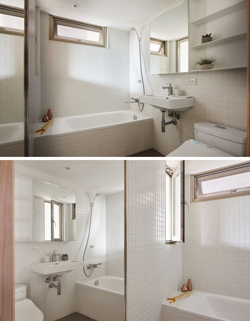 Bright white tiles and dual mirrors make a small bathroom feel open and airy in a 236 sq ft Taipei apartment