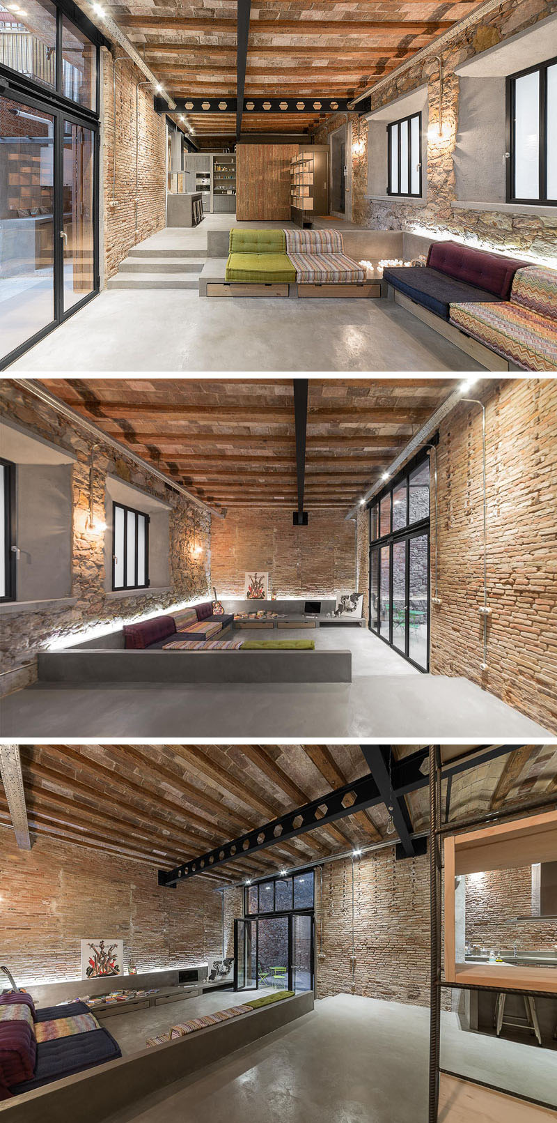 Original brick walls and a built-in sofa with colorful cushions leads to folding glass doors that open to a private courtyard, framed by decorative steel screens.