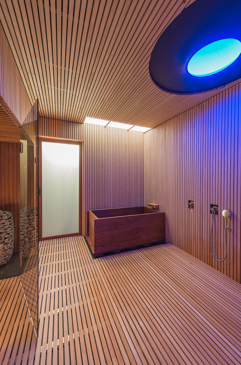 The home’s sauna takes relaxation to the next level with a sleek, wood-lined interior that wraps from floor to ceiling, while a soaking tub adds a luxurious touch.