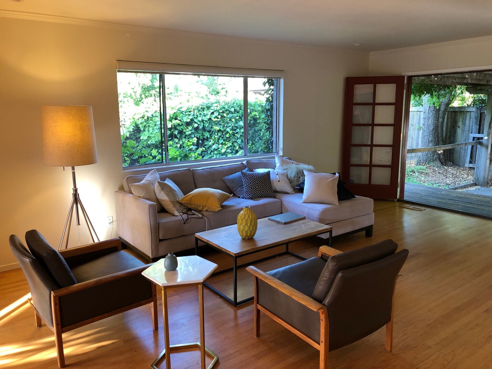 BEFORE - The interiors of the original 1970s home felt outdated and closed off. Low, flat ceilings made the rooms feel compressed, while small openings limited both natural light and views of the surrounding garden. 