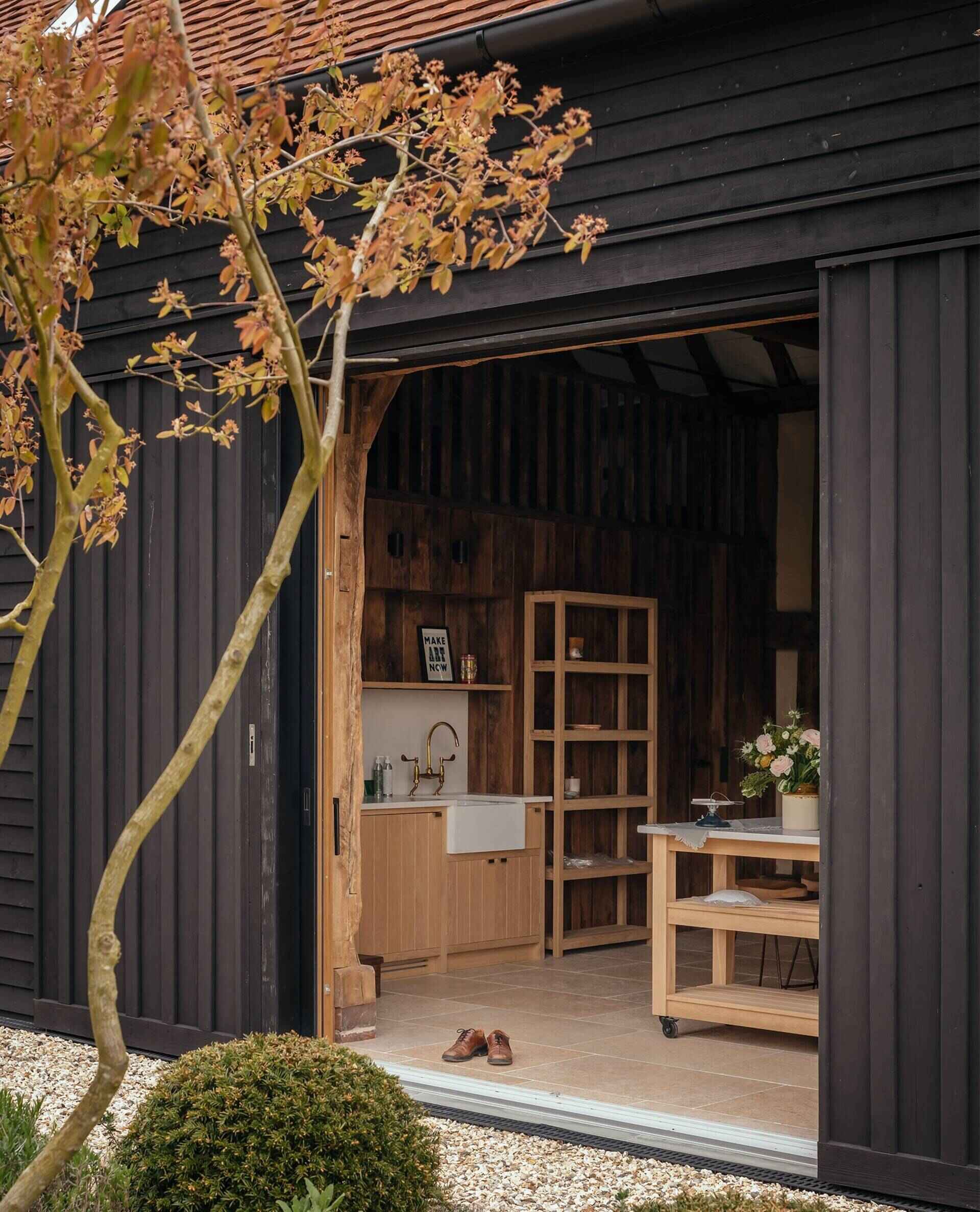 A secondary area offers its own small kitchen and loft bedroom, perfect for extended stays or hosting guests. This self-contained area mirrors the warmth of the main spaces while giving privacy and independence.