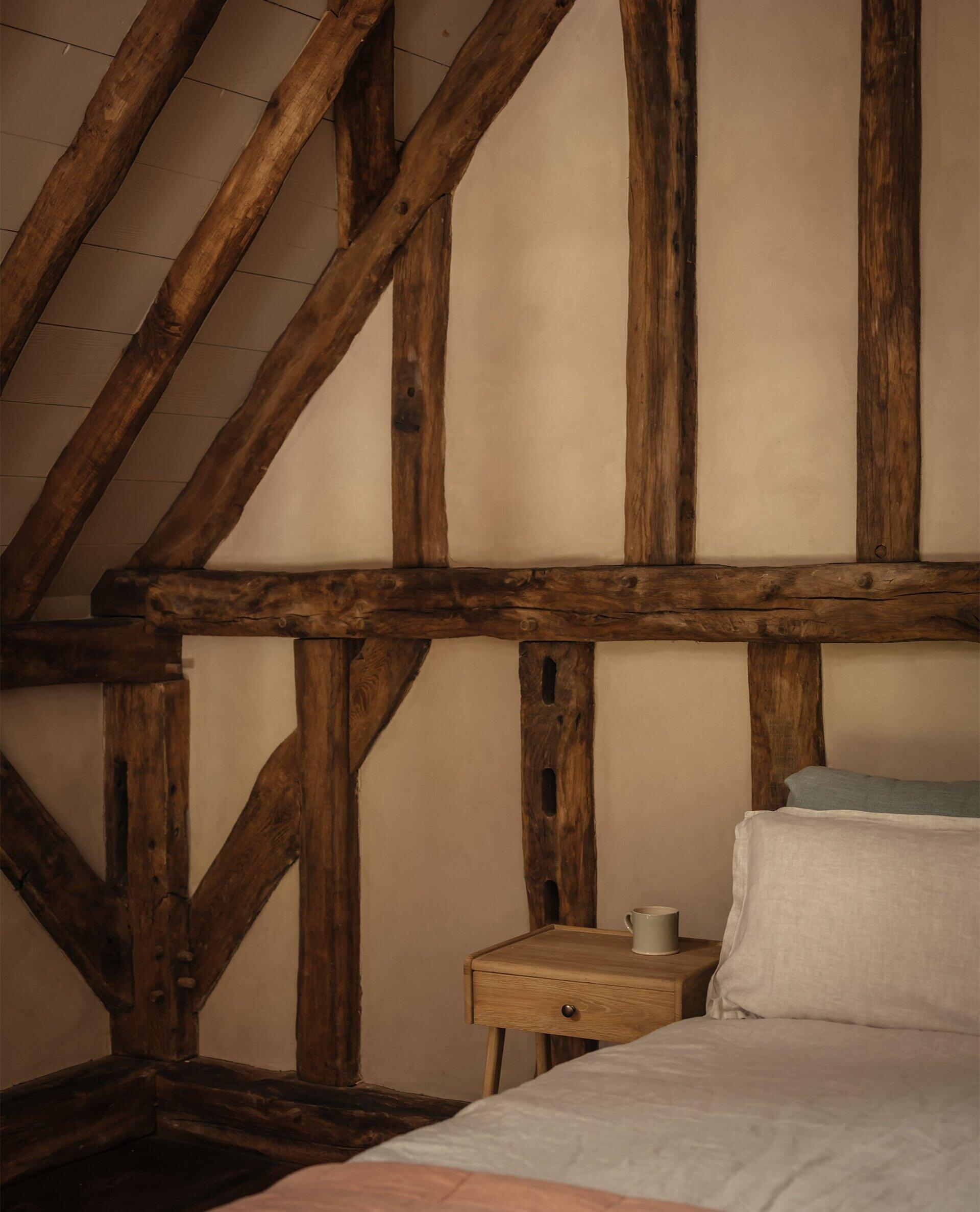 A secondary area offers its own small kitchen and loft bedroom, perfect for extended stays or hosting guests. This self-contained area mirrors the warmth of the main spaces while giving privacy and independence.