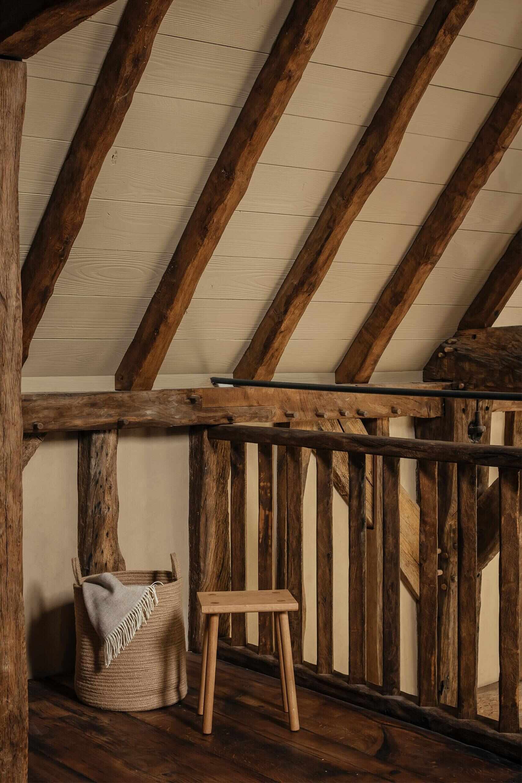 A secondary area offers its own small kitchen and loft bedroom, perfect for extended stays or hosting guests. This self-contained area mirrors the warmth of the main spaces while giving privacy and independence.