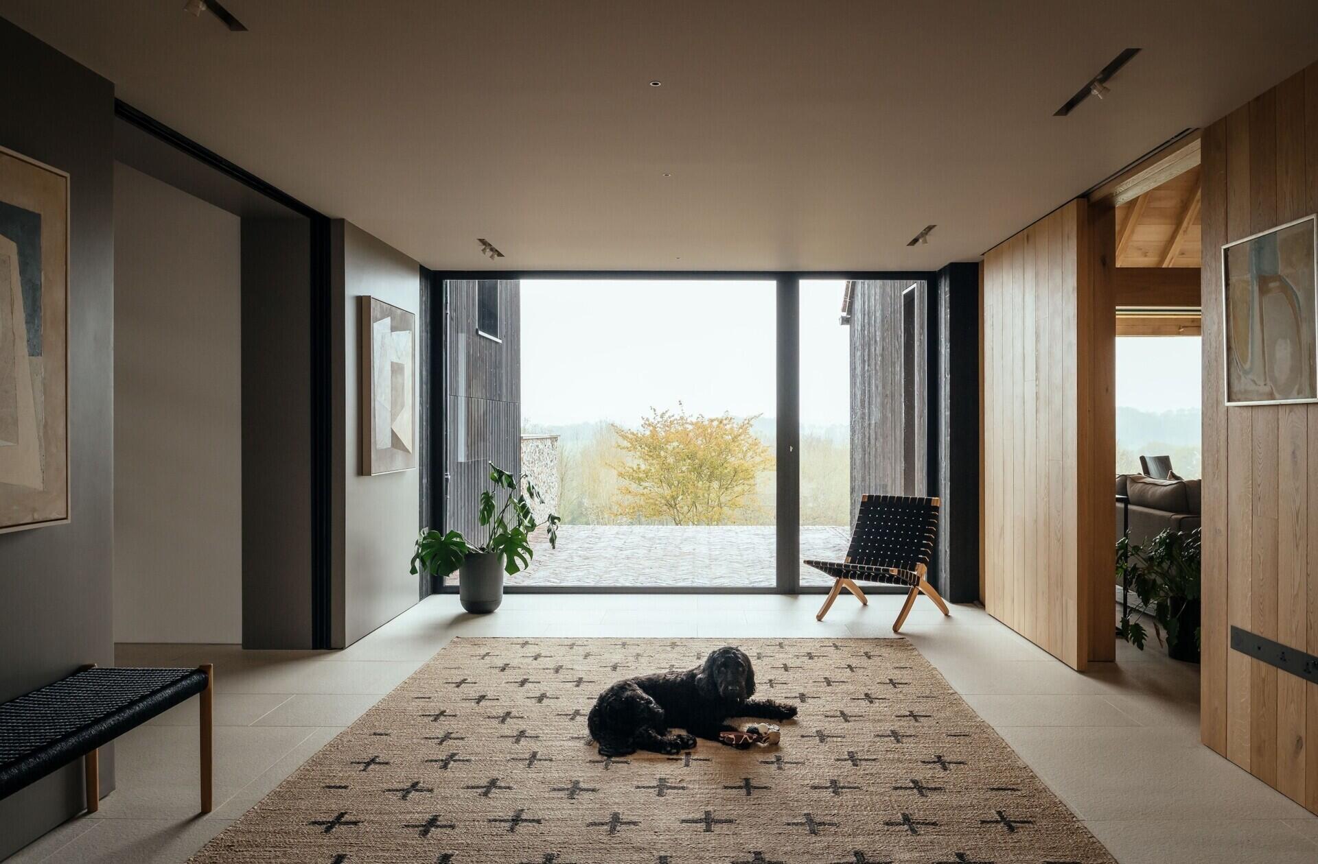 A modern barn-inspired home with floor-to-ceiling glass, oak framing, and interiors filled with natural light.