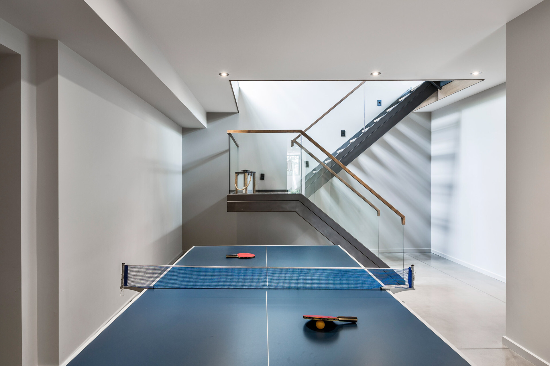 A simple basement setup provides a flexible games room for casual family living.