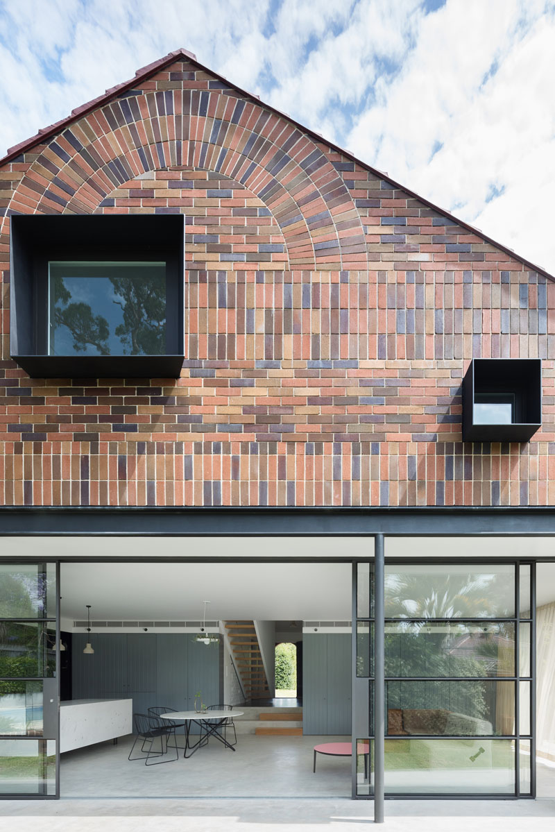 A dramatic gabled brick and glass addition brings light and scale to the family home.