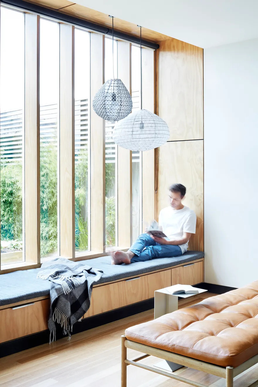 One of the extension’s standout features is a built-in window seat tucked beside the living room. Framed by tall north-facing windows, it’s a perfect sunlit nook to read, relax, or simply gaze into the garden. The seat also hides discreet storage beneath an upholstered cushion, marrying comfort with practicality.