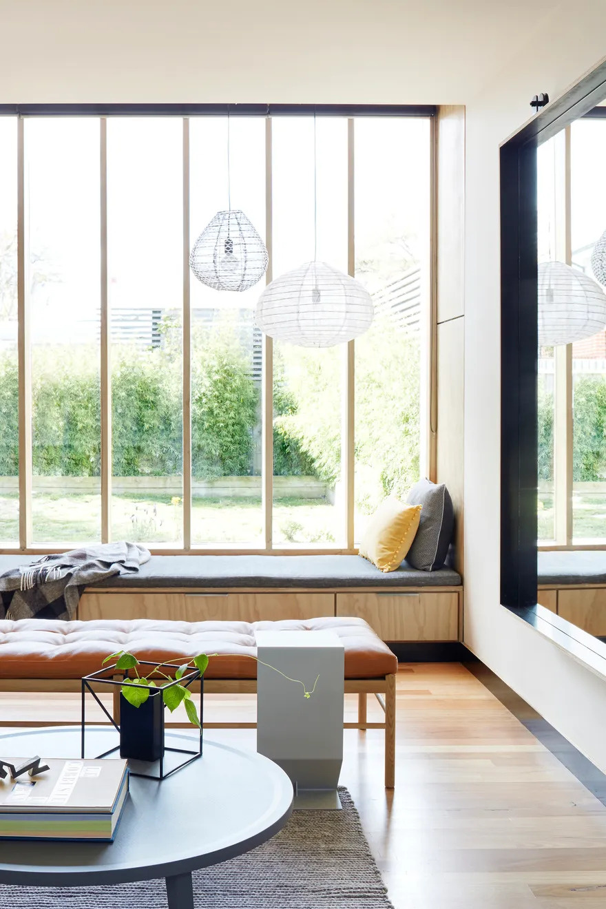 One of the extension’s standout features is a built-in window seat tucked beside the living room. Framed by tall north-facing windows, it’s a perfect sunlit nook to read, relax, or simply gaze into the garden. The seat also hides discreet storage beneath an upholstered cushion, marrying comfort with practicality.