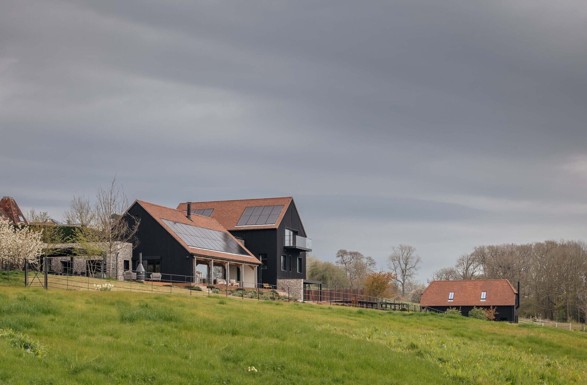 Discover a barn-inspired home in the North Downs where flint walls and oak beams frame a sustainable family lifestyle.