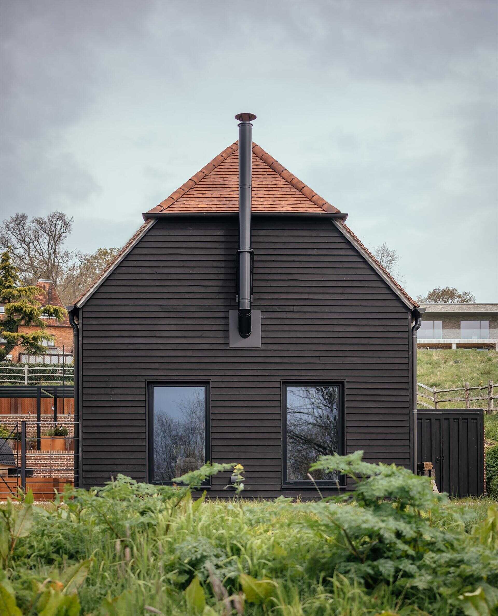 Discover a barn-inspired home in the North Downs where flint walls and oak beams frame a sustainable family lifestyle.