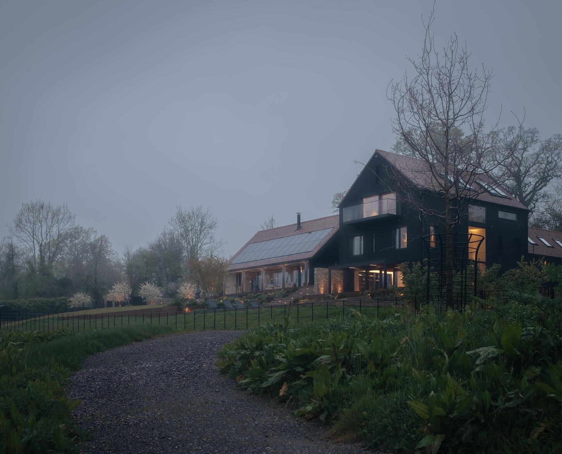 Discover a barn-inspired home in the North Downs where flint walls and oak beams frame a sustainable family lifestyle.