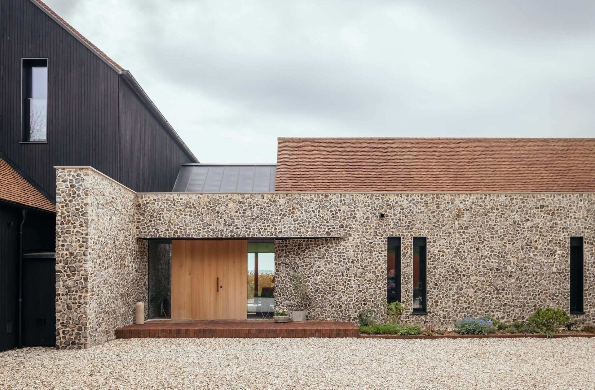 Discover a barn-inspired home in the North Downs where flint walls and oak beams frame a sustainable family lifestyle.