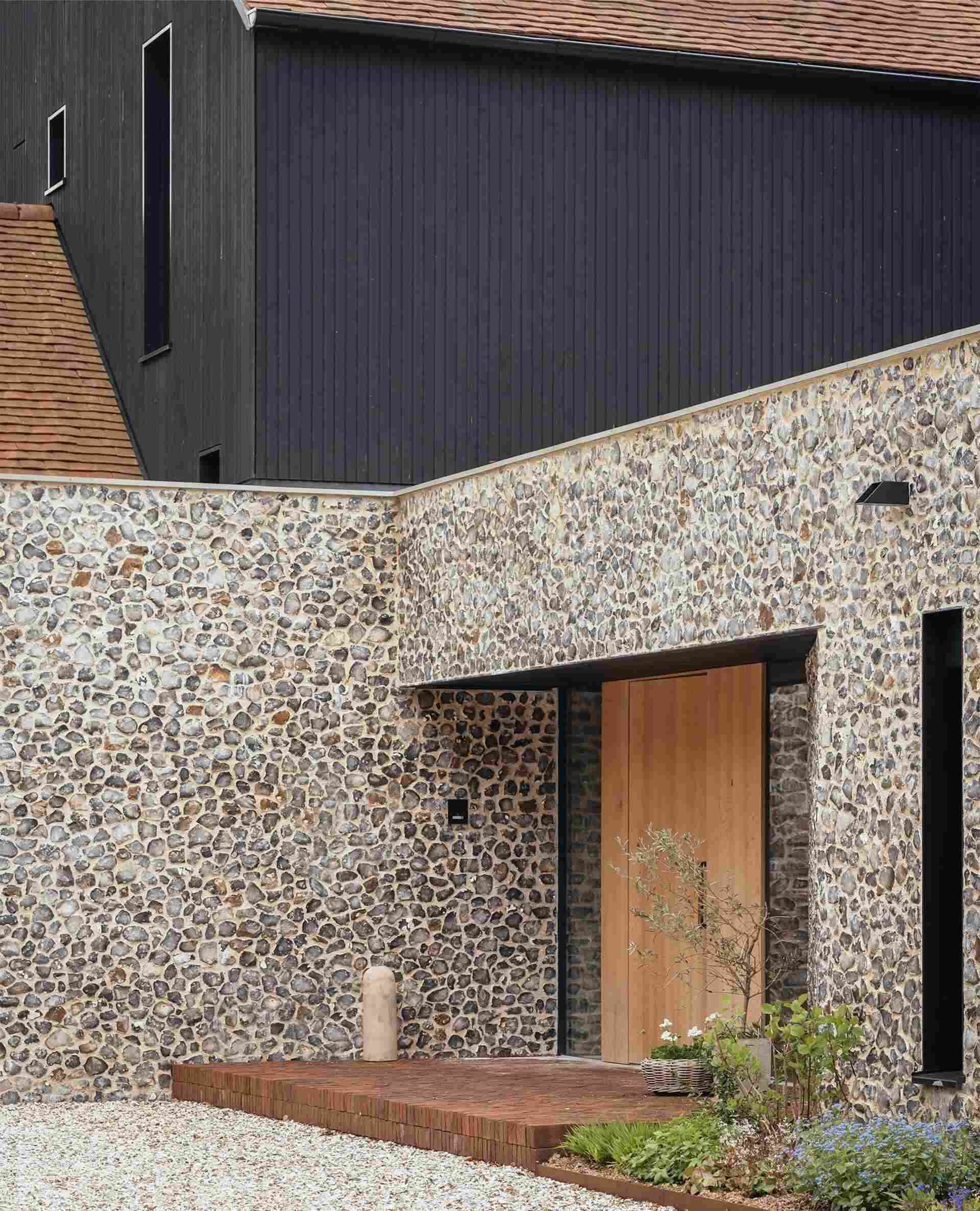 Discover a barn-inspired home in the North Downs where flint walls and oak beams frame a sustainable family lifestyle.