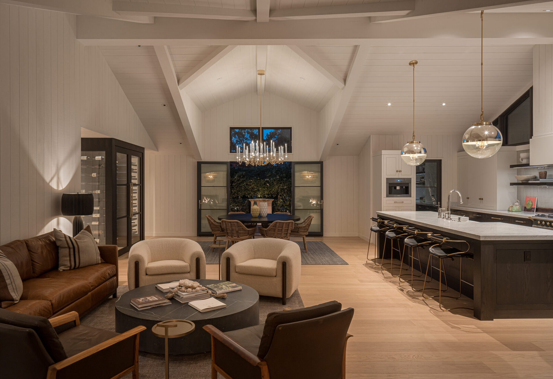 This remodeled living room was expanded and infused with natural light. By lifting the ceiling and connecting it visually with the garden, the space now feels open and vibrant. A triangular window on the western wall adds a unique detail, framing unexpected views of the surrounding hills.