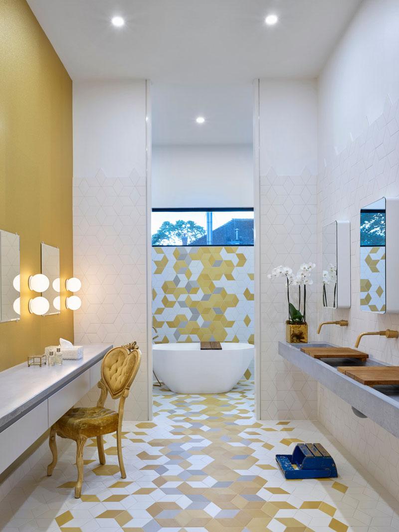 The three daughters share a bathroom designed for function and fun. With three sinks, three makeup stations, and colorful geometric tiles, it turns a daily routine into a playful experience.
