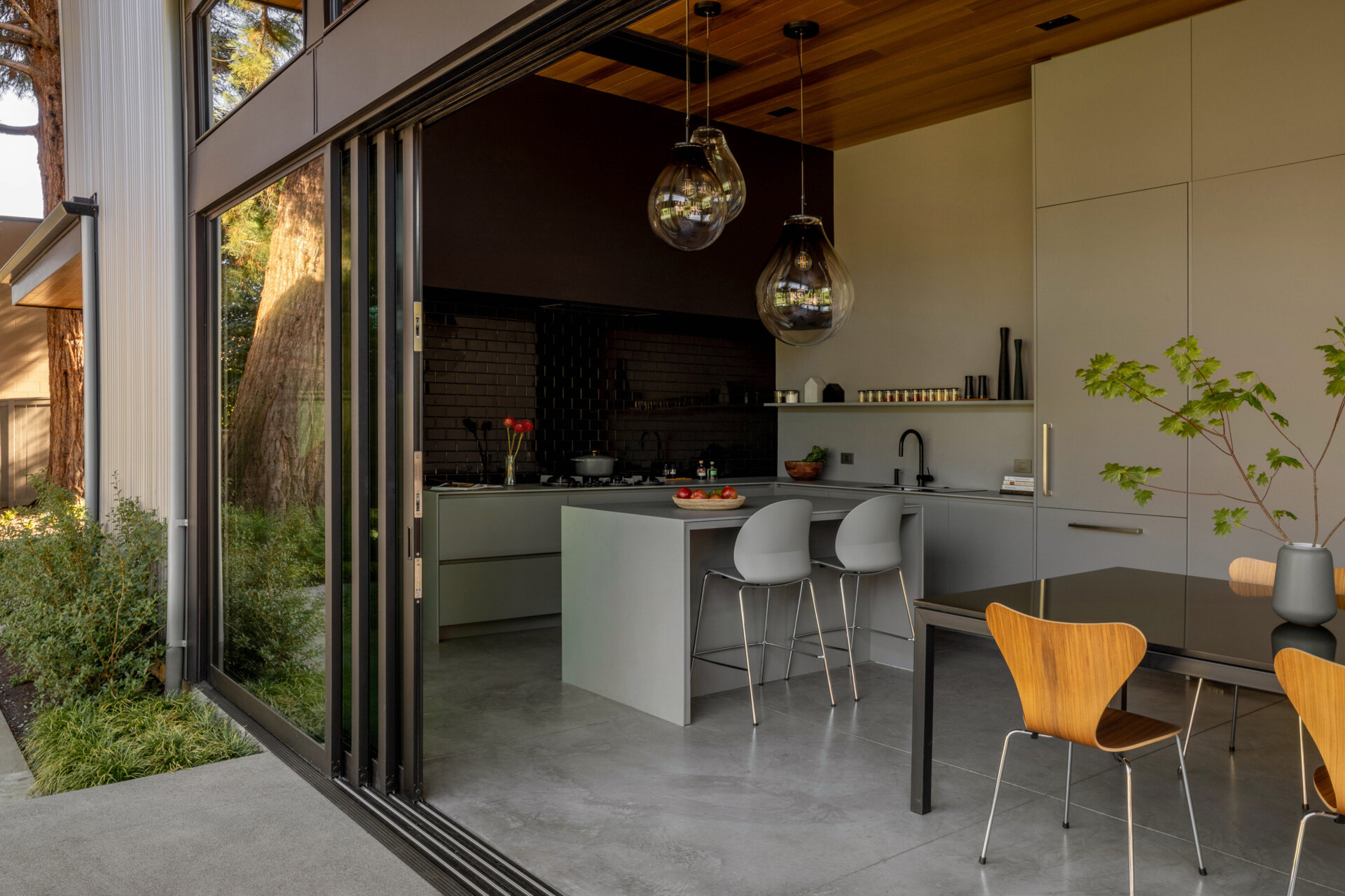 A durable Dekton kitchen with seamless finishes, hidden coffee station, and indoor-outdoor flow, ideal for family gatherings and entertaining.