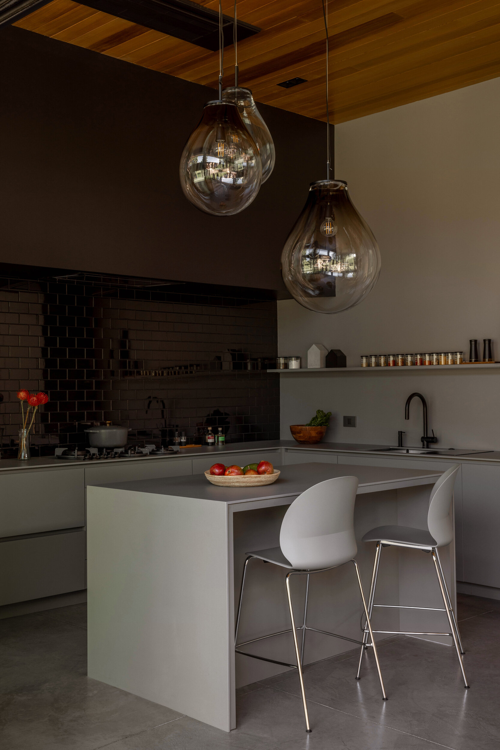 A durable Dekton kitchen with seamless finishes, hidden coffee station, and indoor-outdoor flow, ideal for family gatherings and entertaining.