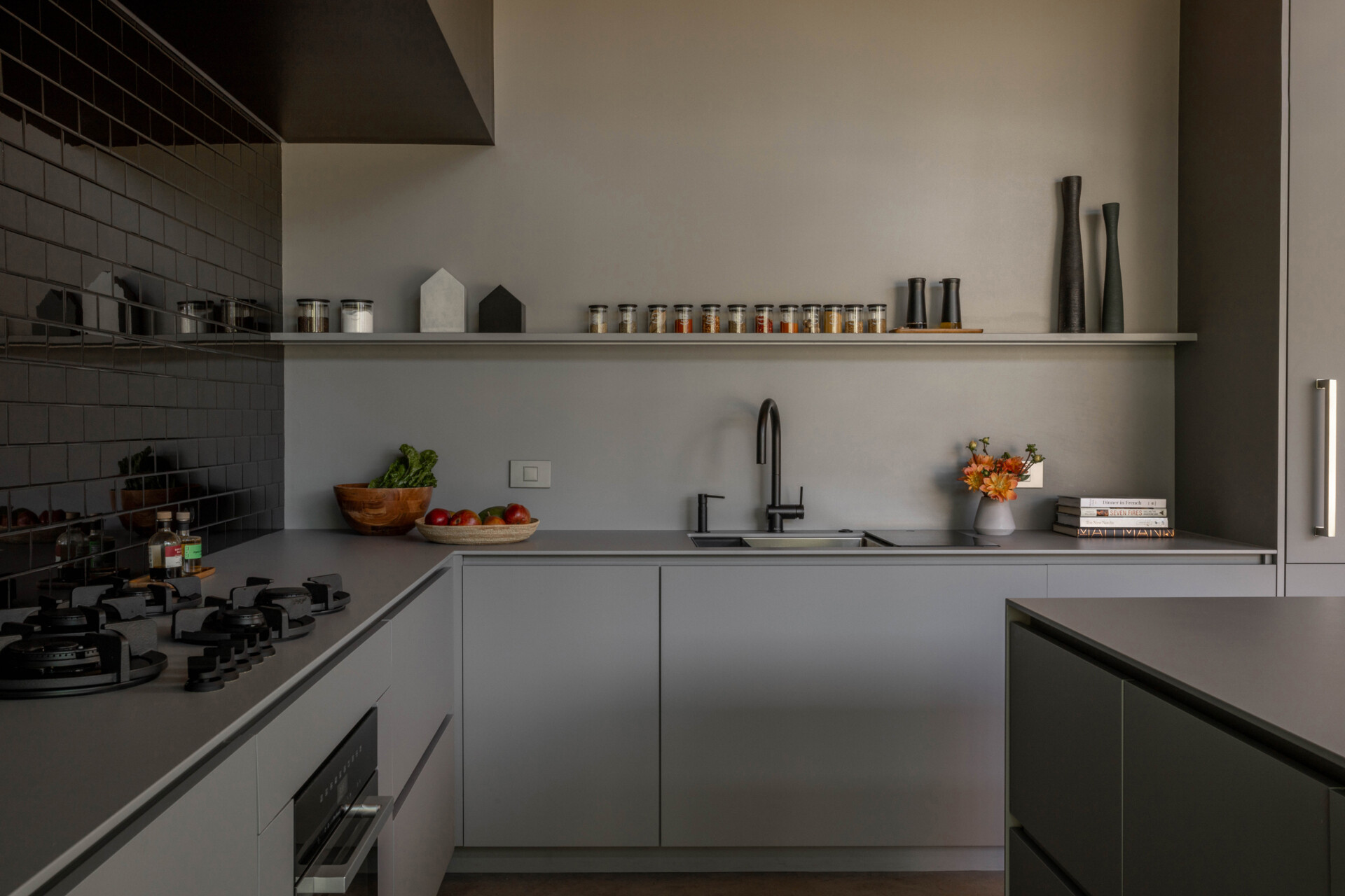 A durable Dekton kitchen with seamless finishes, hidden coffee station, and indoor-outdoor flow, ideal for family gatherings and entertaining.