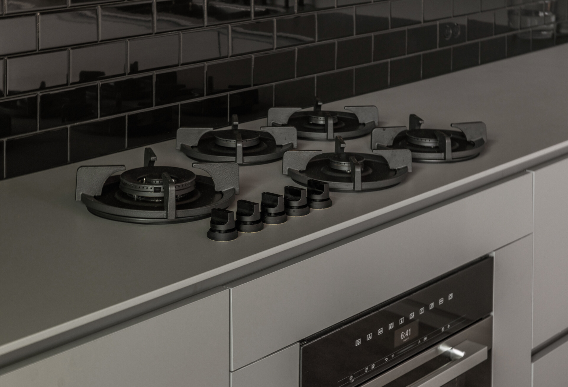 A durable Dekton kitchen with seamless finishes, hidden coffee station, and indoor-outdoor flow, ideal for family gatherings and entertaining.