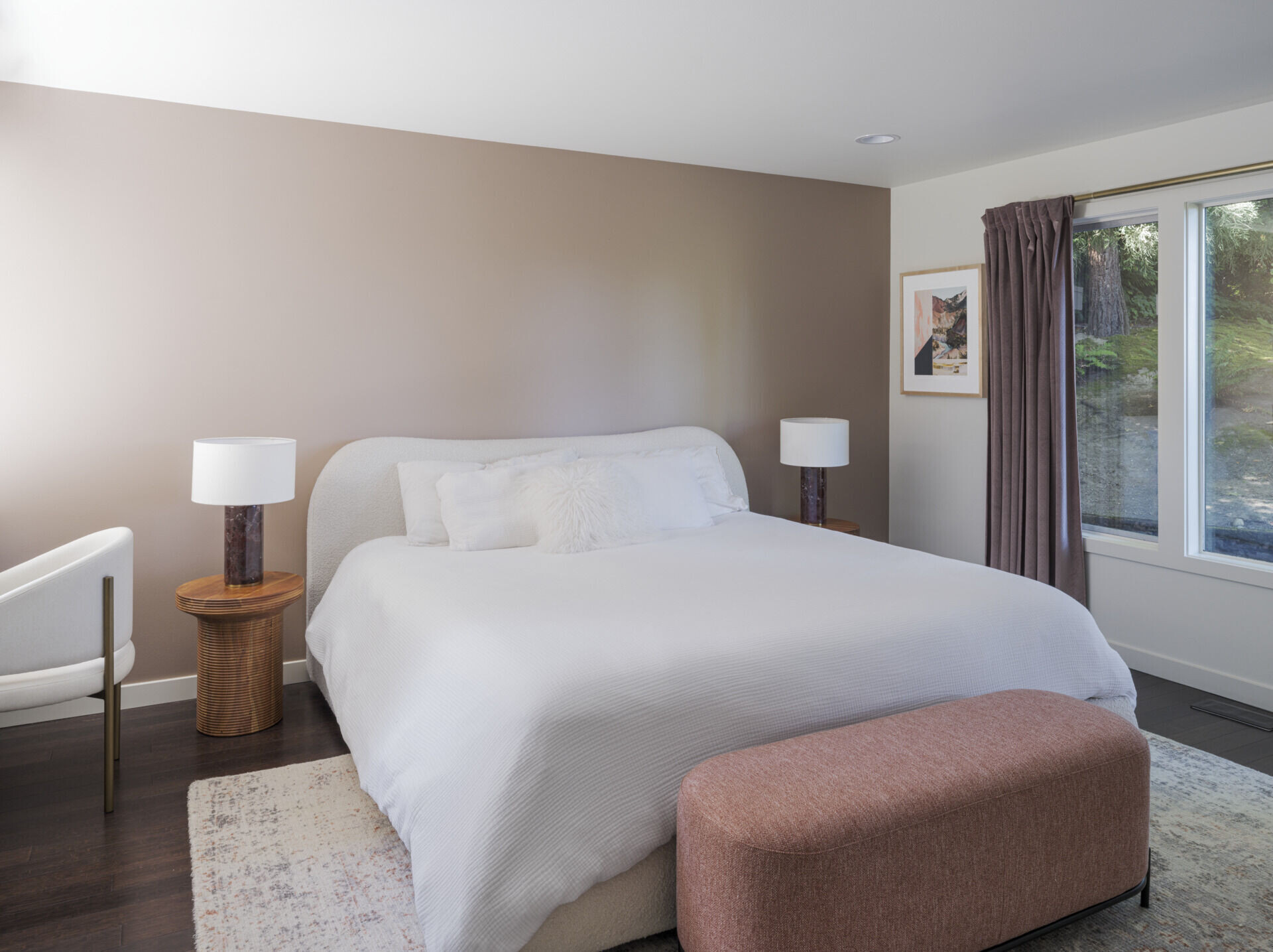 This bedroom is neutral in its appearance, with soft curves and comfortable furnishings