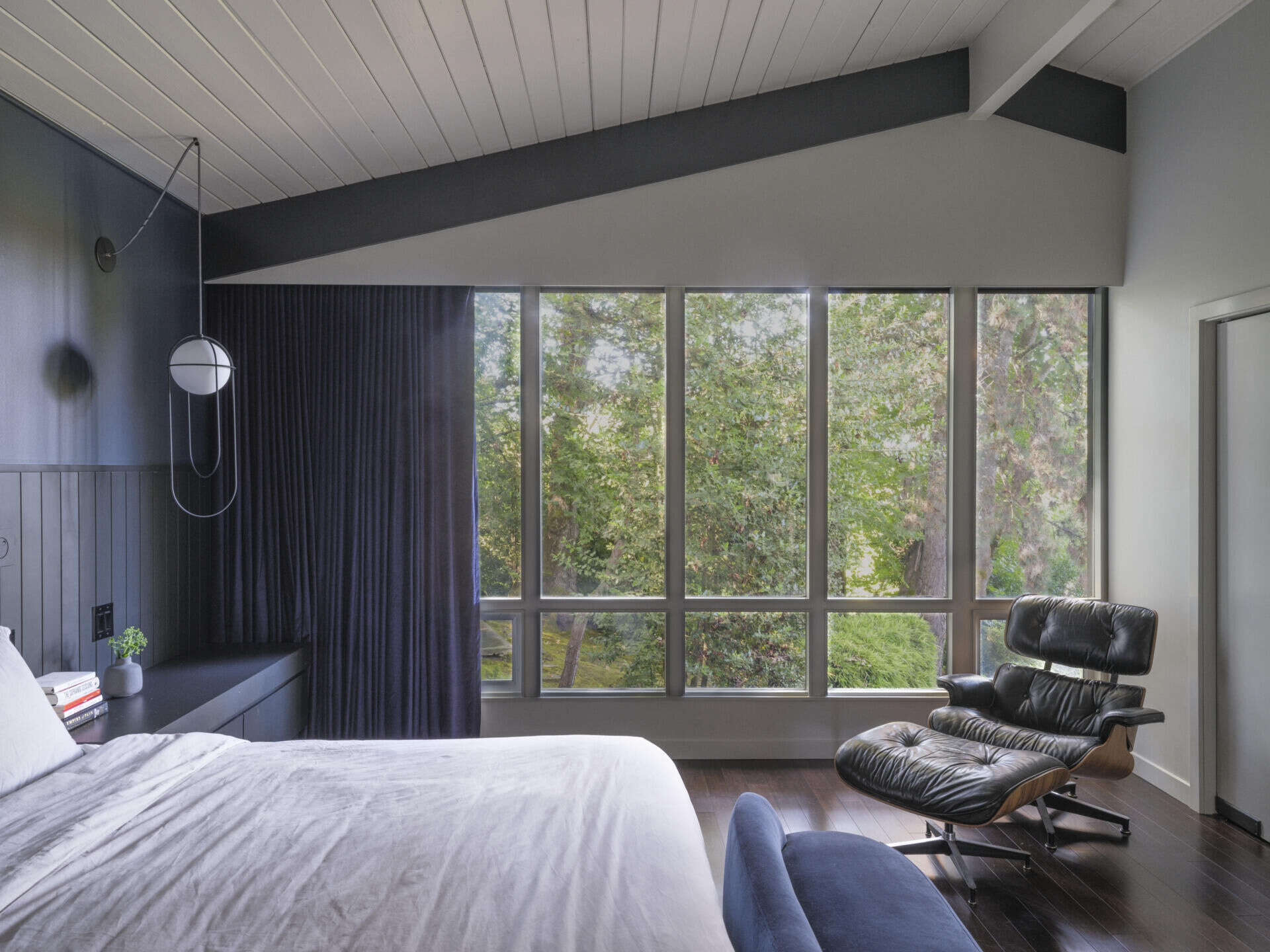 Rich black-stained millwork, charcoal-painted beams, and moody lighting set a luxurious tone. The reconfiguration also allowed for dual closets, a favorite feature for the frequent-traveling homeowners.