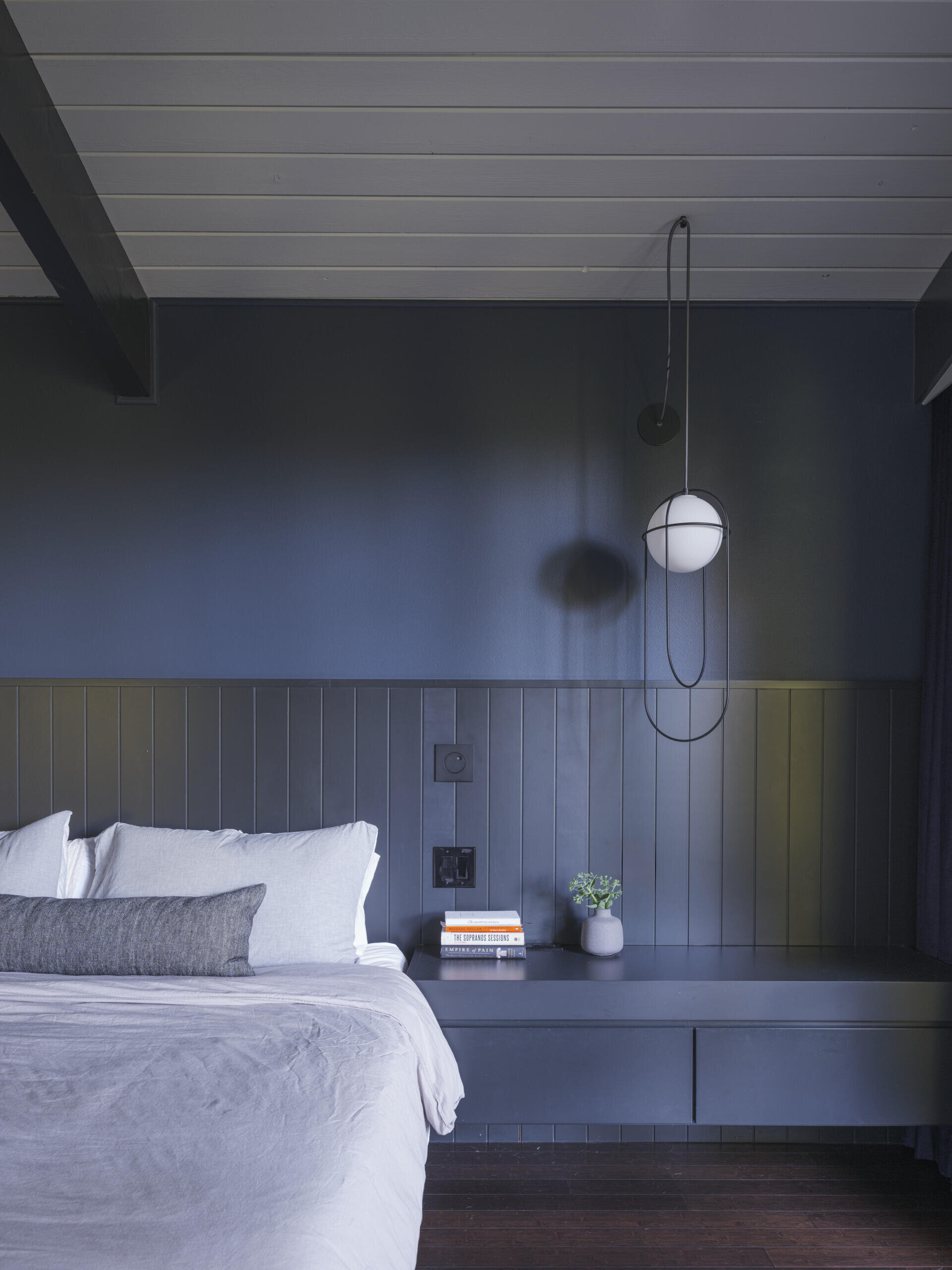 Rich black-stained millwork, charcoal-painted beams, and moody lighting set a luxurious tone. The reconfiguration also allowed for dual closets, a favorite feature for the frequent-traveling homeowners.
