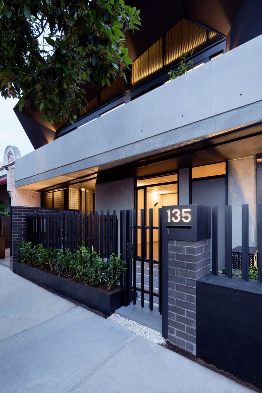 A modern apartment building in Melbourne with two welcoming entrances, one private, one shared, designed to balance individuality and community.