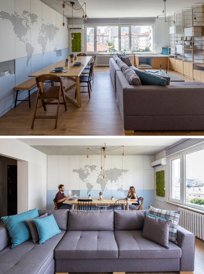 An open-plan living and dining room with built-in shelving and a window seat.
