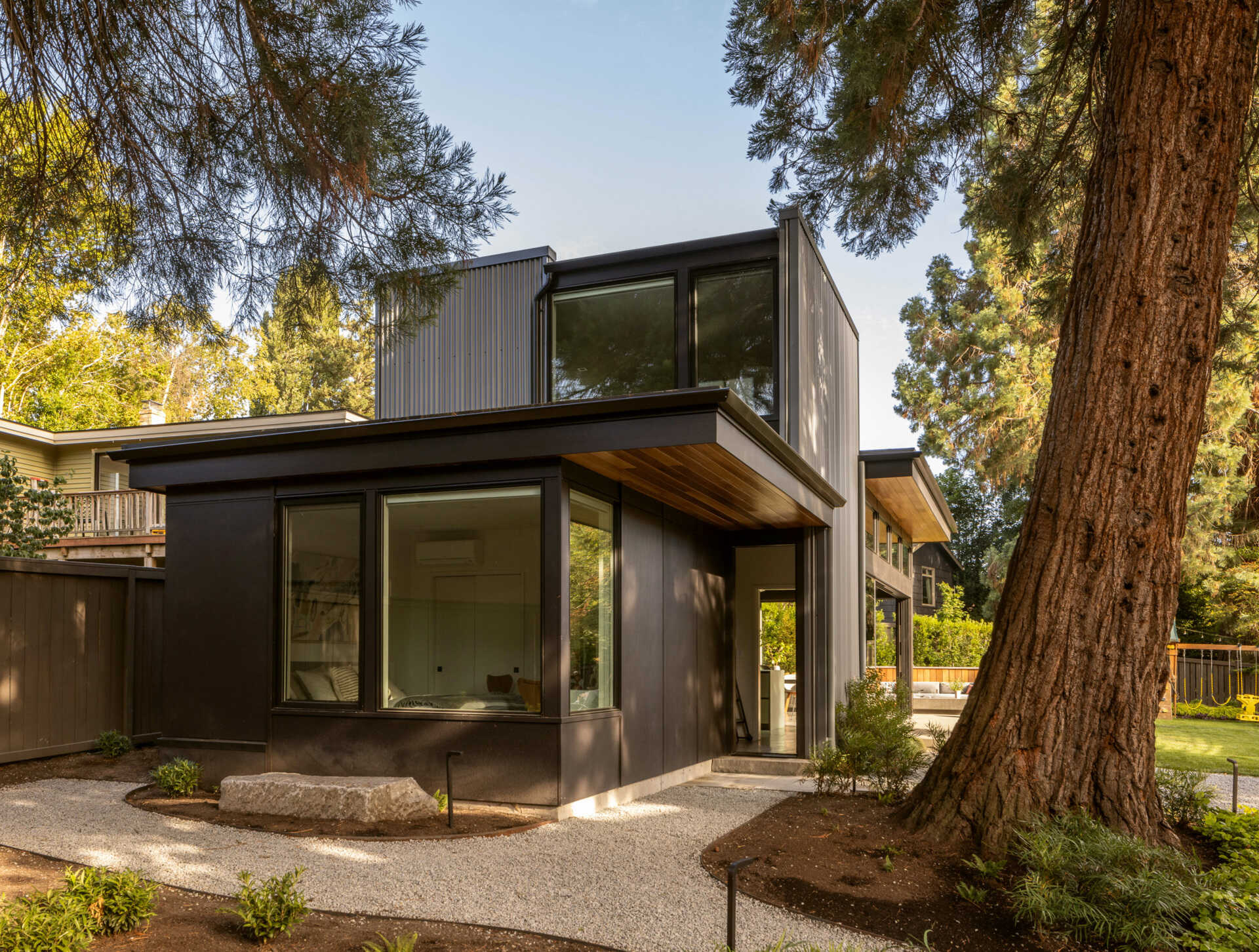 A modern Seattle structure clad in metal and cement siding with warm wood accents, designed for family gatherings and entertaining.