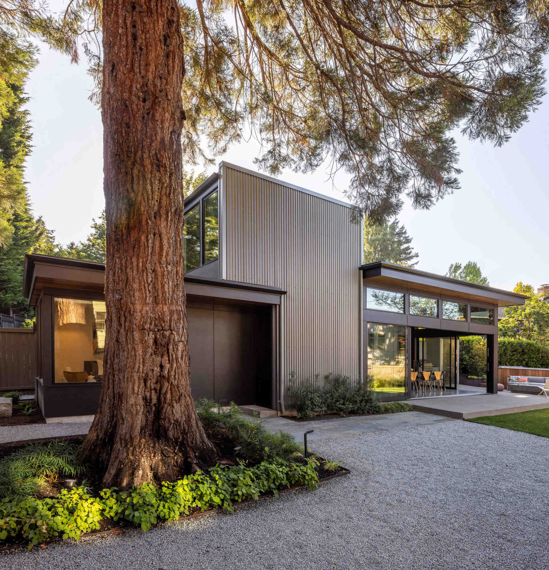 A modern Seattle structure clad in metal and cement siding with warm wood accents, designed for family gatherings and entertaining.