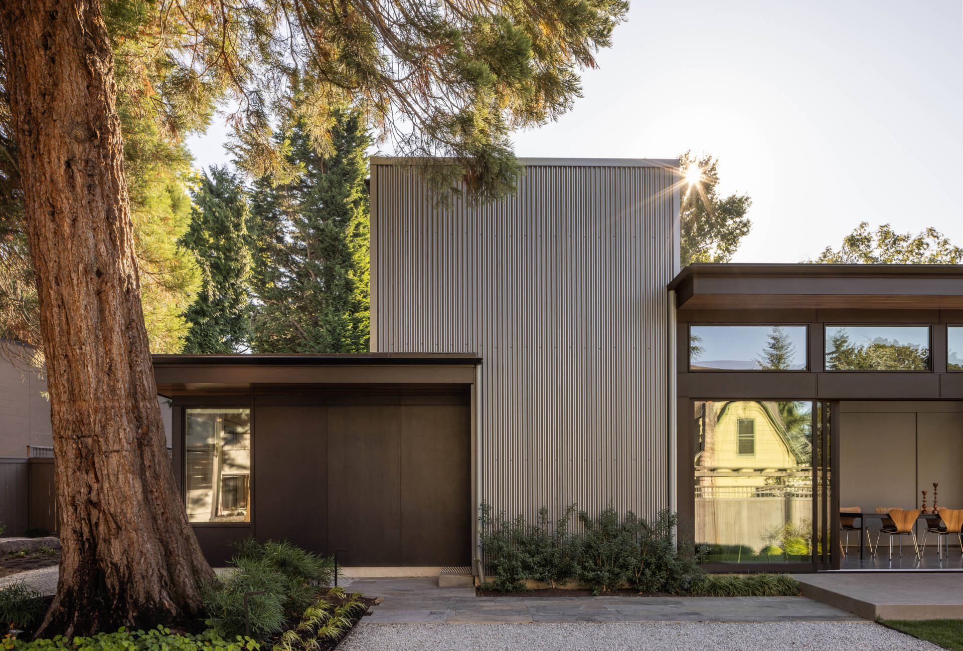 A modern Seattle structure clad in metal and cement siding with warm wood accents, designed for family gatherings and entertaining.