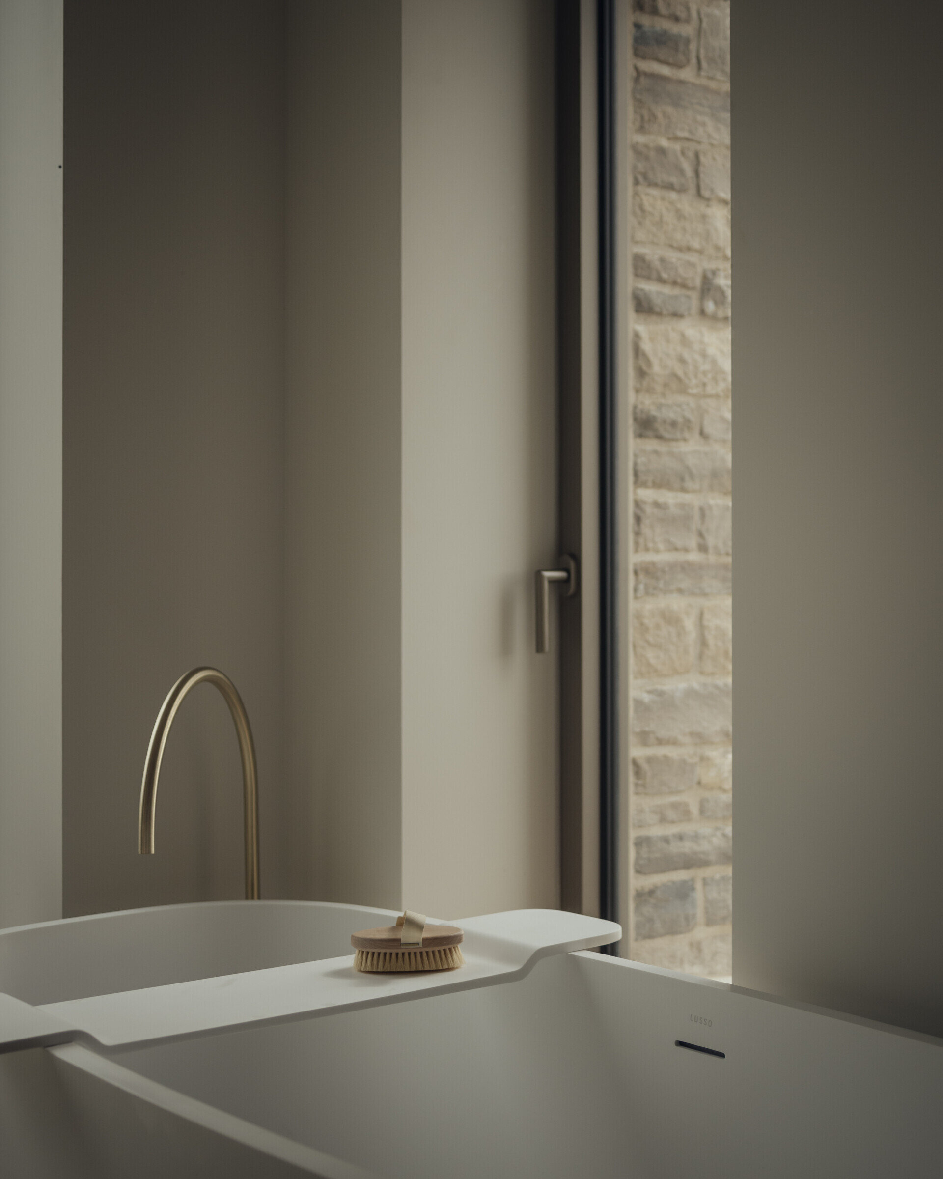 A modern bathroom with a freestanding bathtub, a large window and a double vanity.
