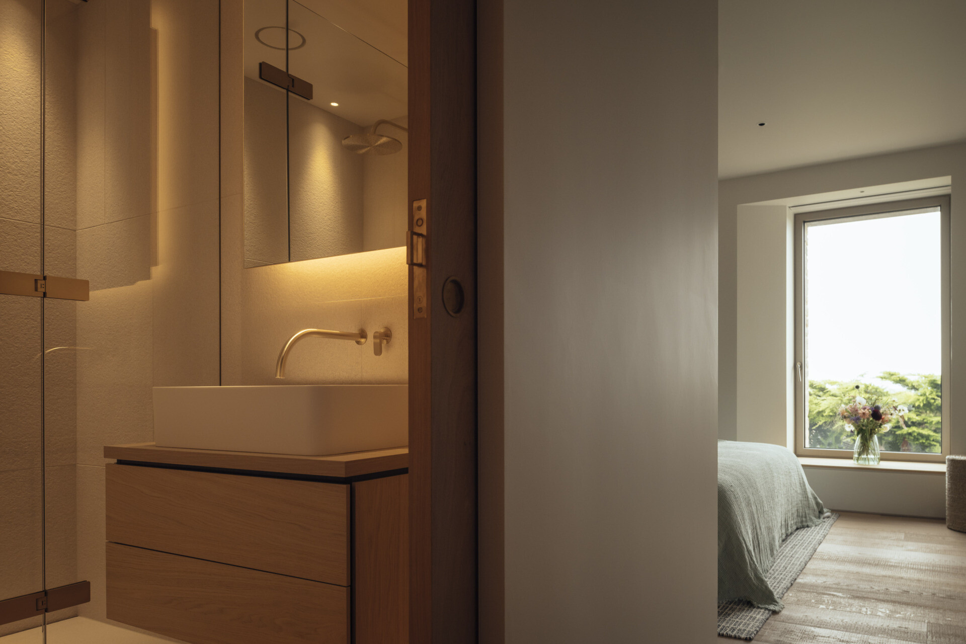A modern bedroom with a window that frames the view.