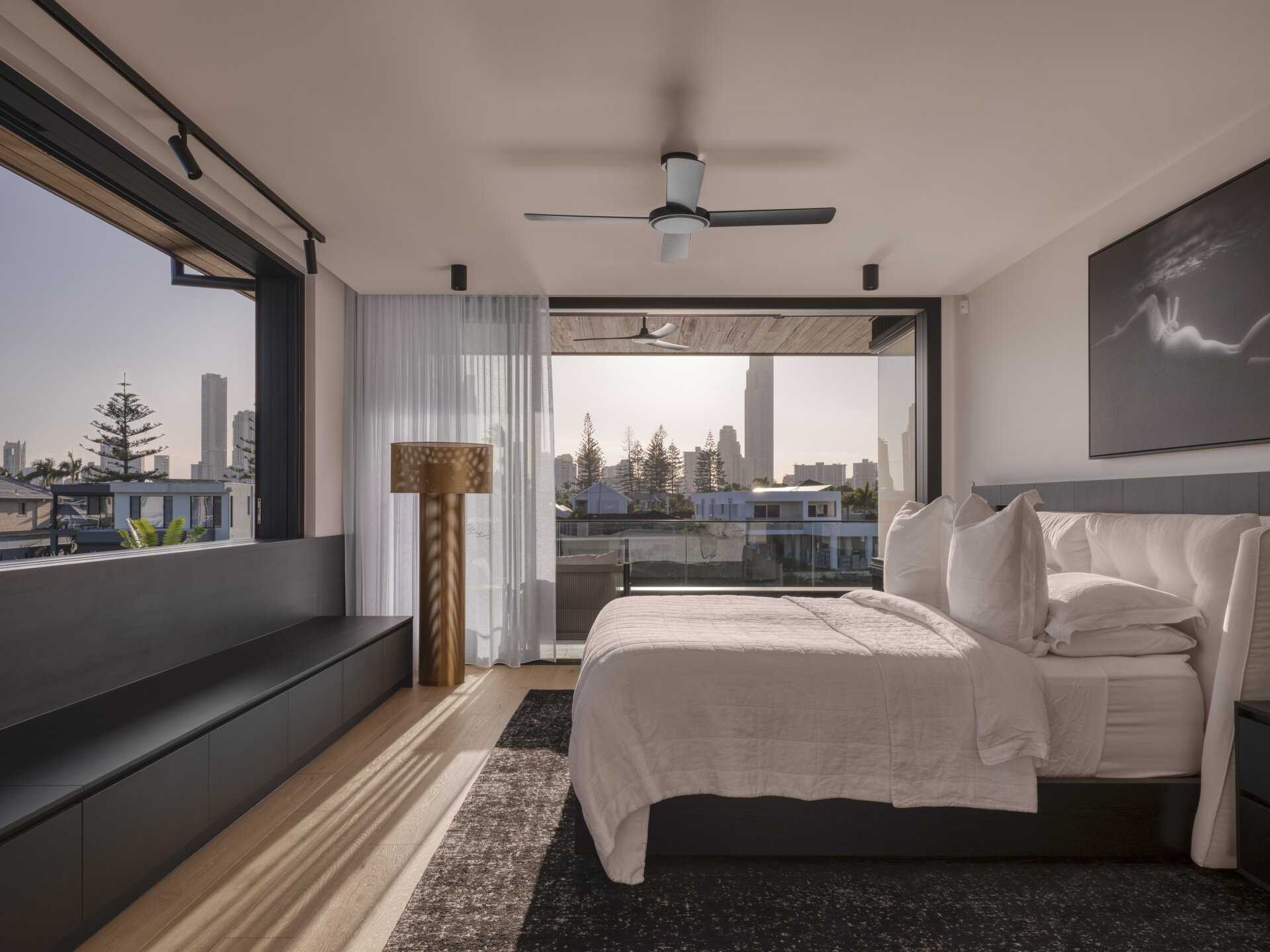 This bedroom prioritizes comfort and connection to nature. Large openings frame greenery, while natural light and ventilation support restful living.