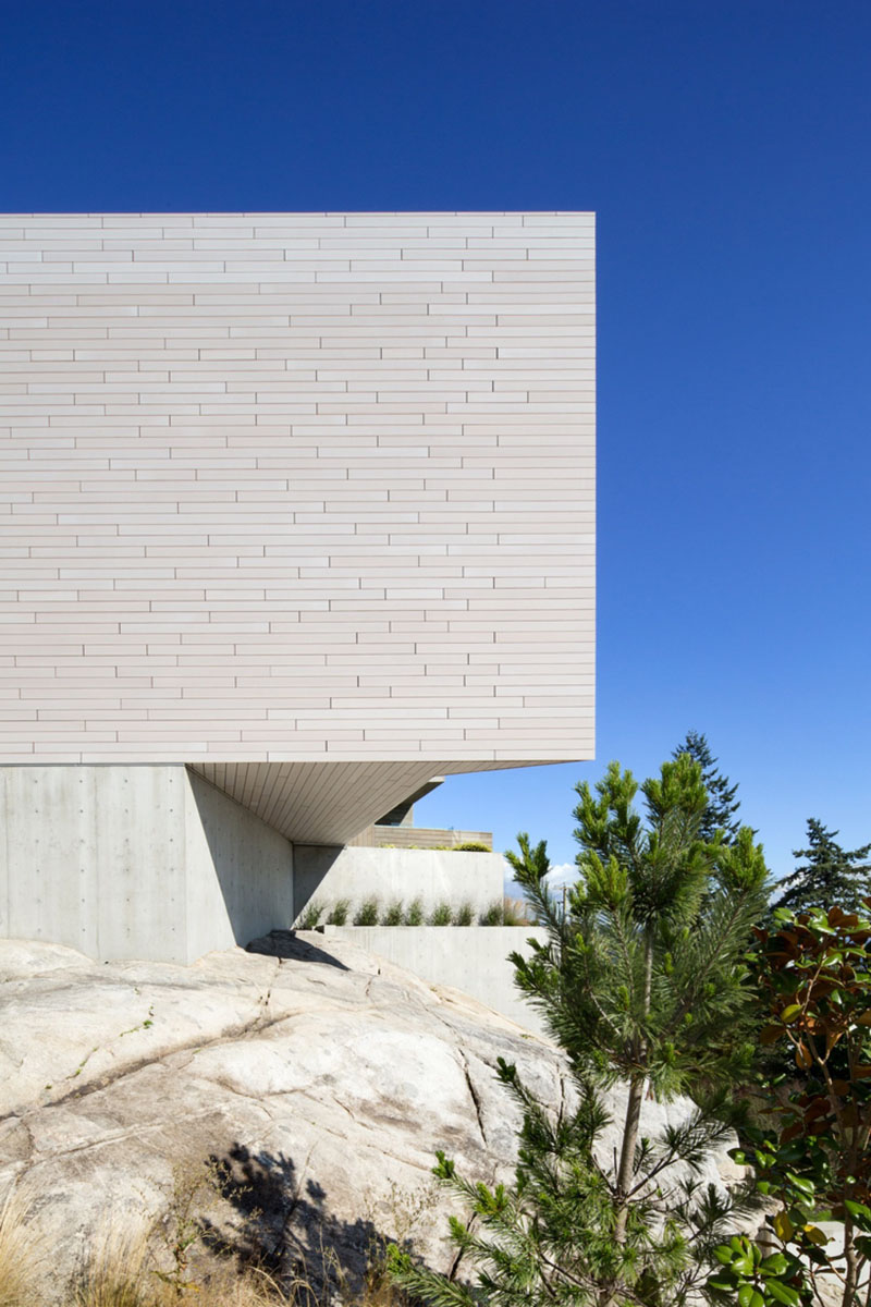 Exterior view of Sunset House showing its sculptural concrete foundation and wood siding.