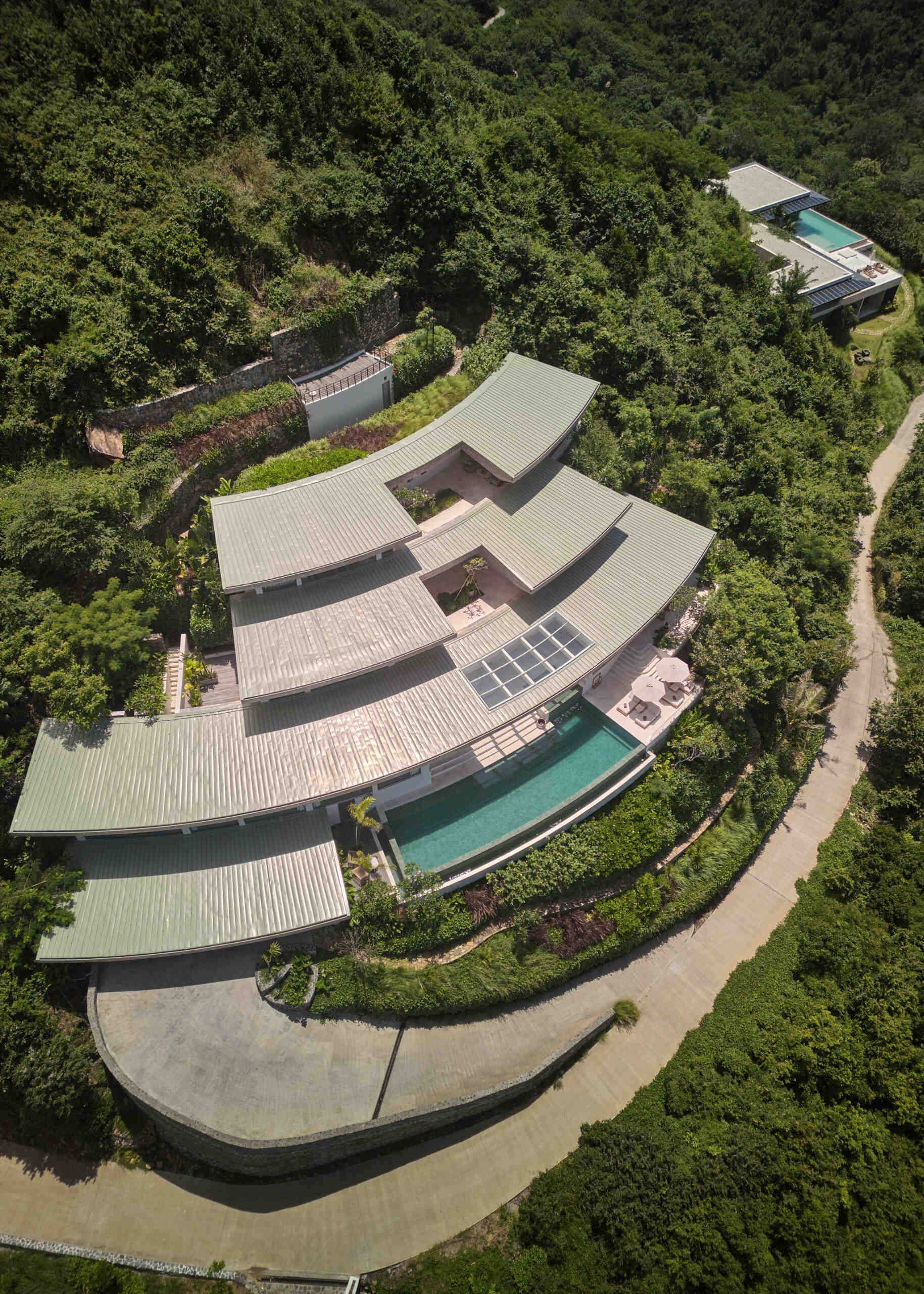 The swimming pool is woven seamlessly into the home’s layout. It's part of the overall landscape, connected by gentle shifts in level and soft transitions that make the pool feel integral rather than separate.