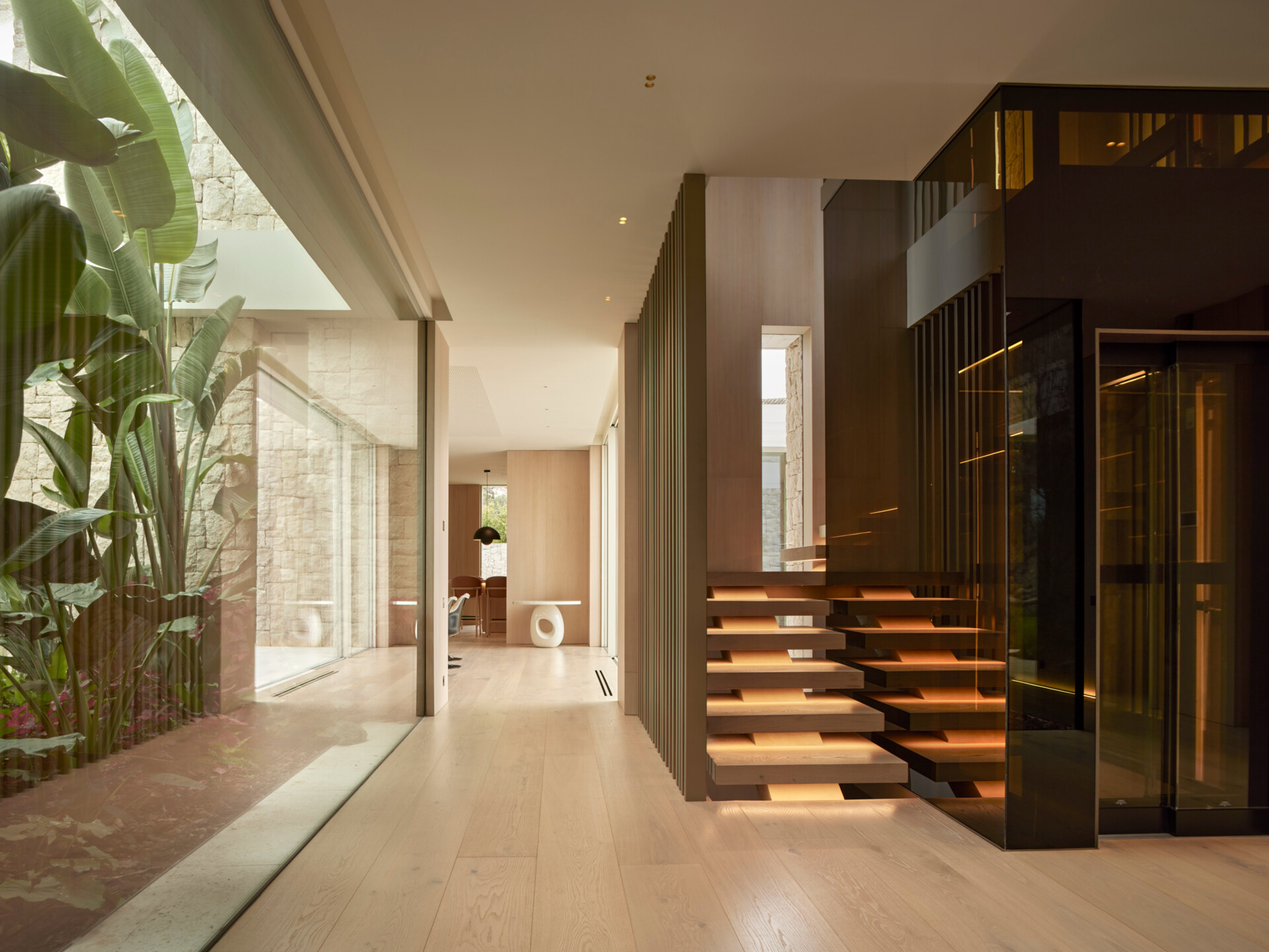A sculptural staircase and lift core that commands the entry.