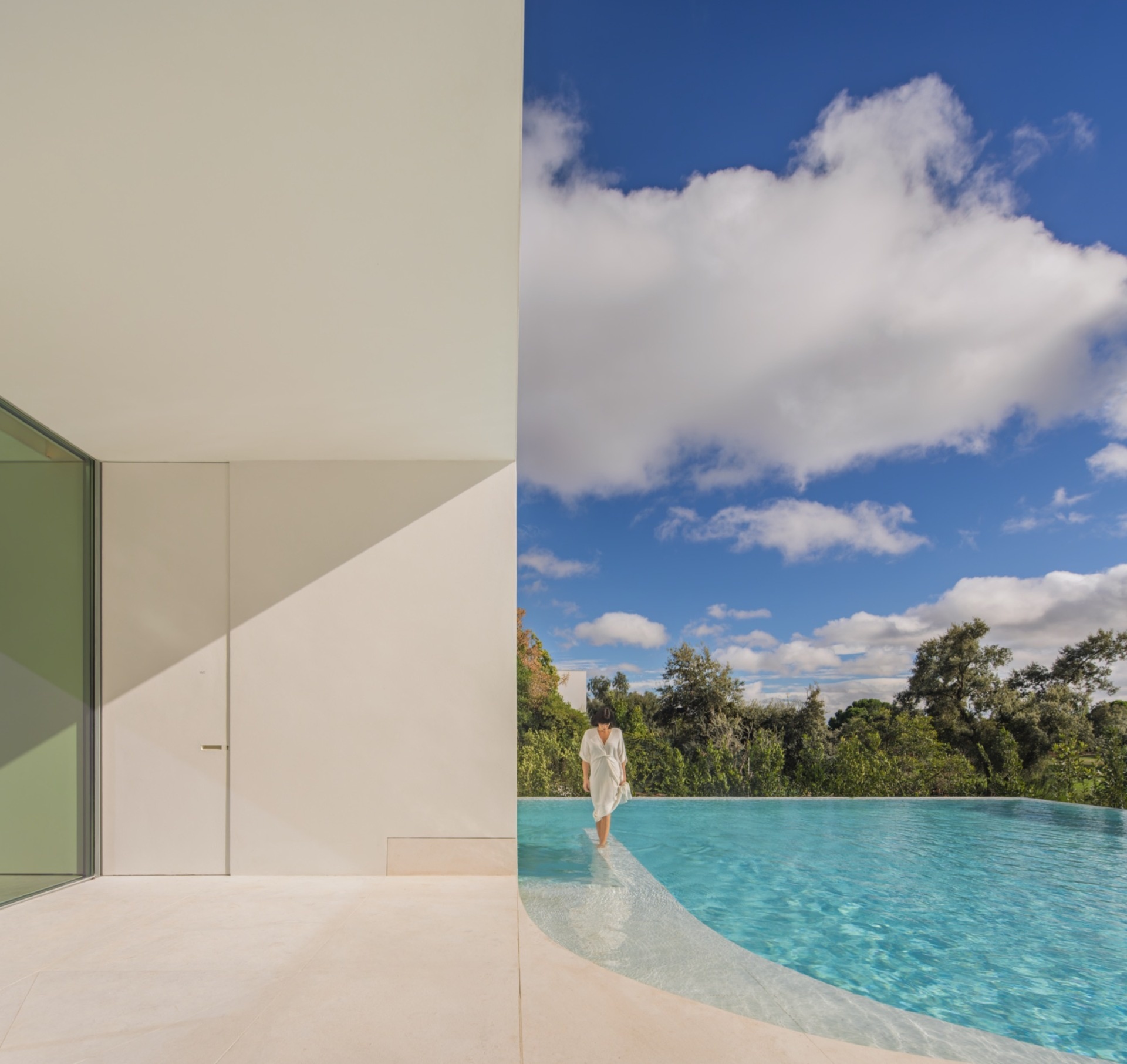 The outdoor pool is designed as an extension of the architecture, with clean lines that mirror the home’s sculptural facade. 