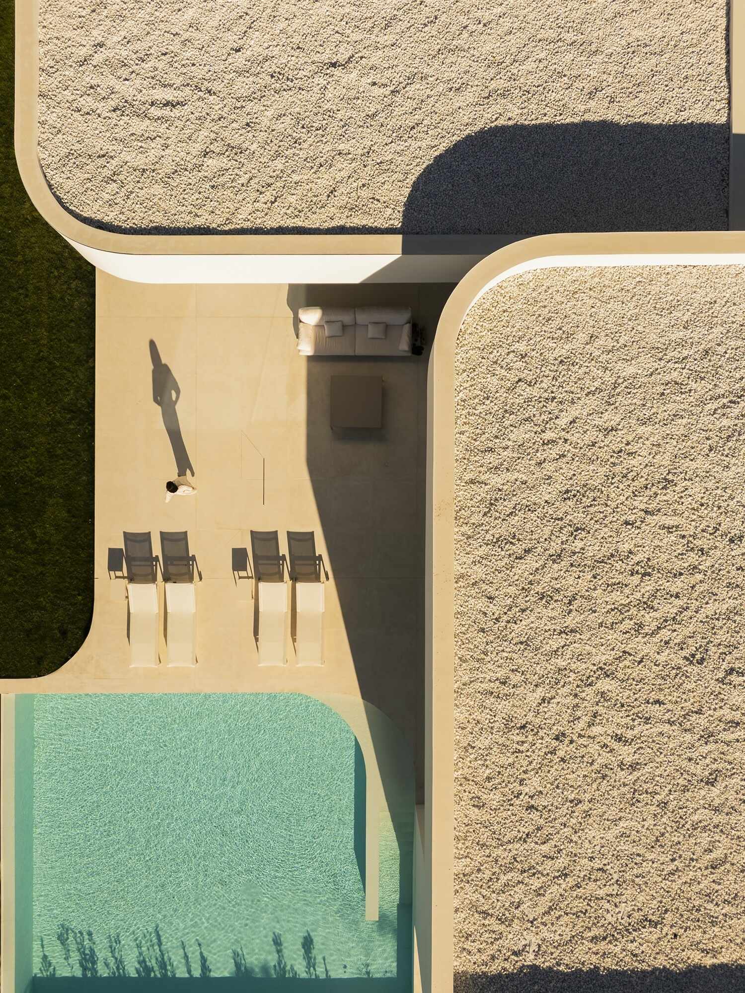 The outdoor pool is designed as an extension of the architecture, with clean lines that mirror the home’s sculptural facade. 