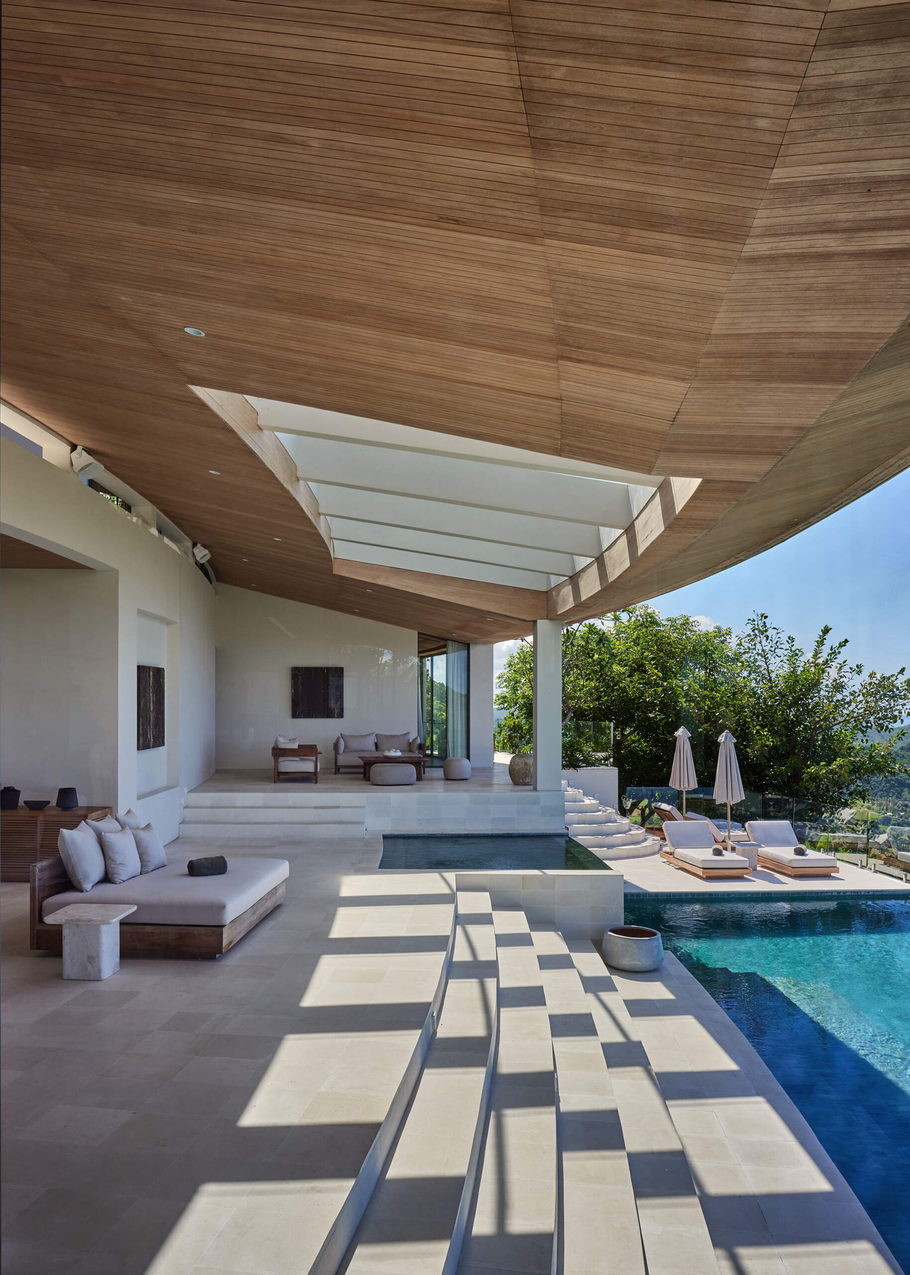 The terrace, with steps down to the main pool, also includes a variety of seating areas, as well as small kid's pool.
