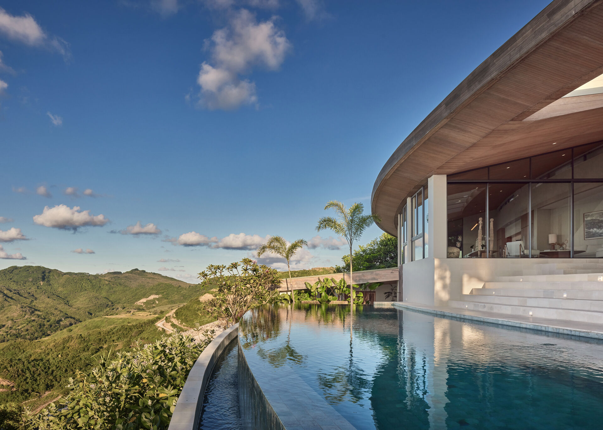The swimming pool is woven seamlessly into the home’s layout. It's part of the overall landscape, connected by gentle shifts in level and soft transitions that make the pool feel integral rather than separate.