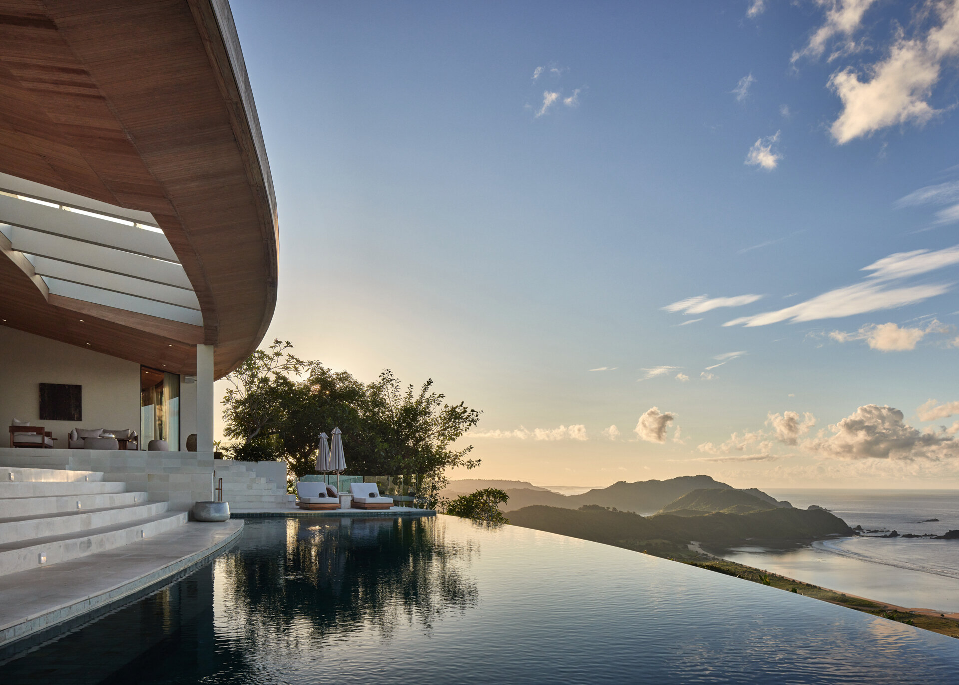The swimming pool is woven seamlessly into the home’s layout. It's part of the overall landscape, connected by gentle shifts in level and soft transitions that make the pool feel integral rather than separate.