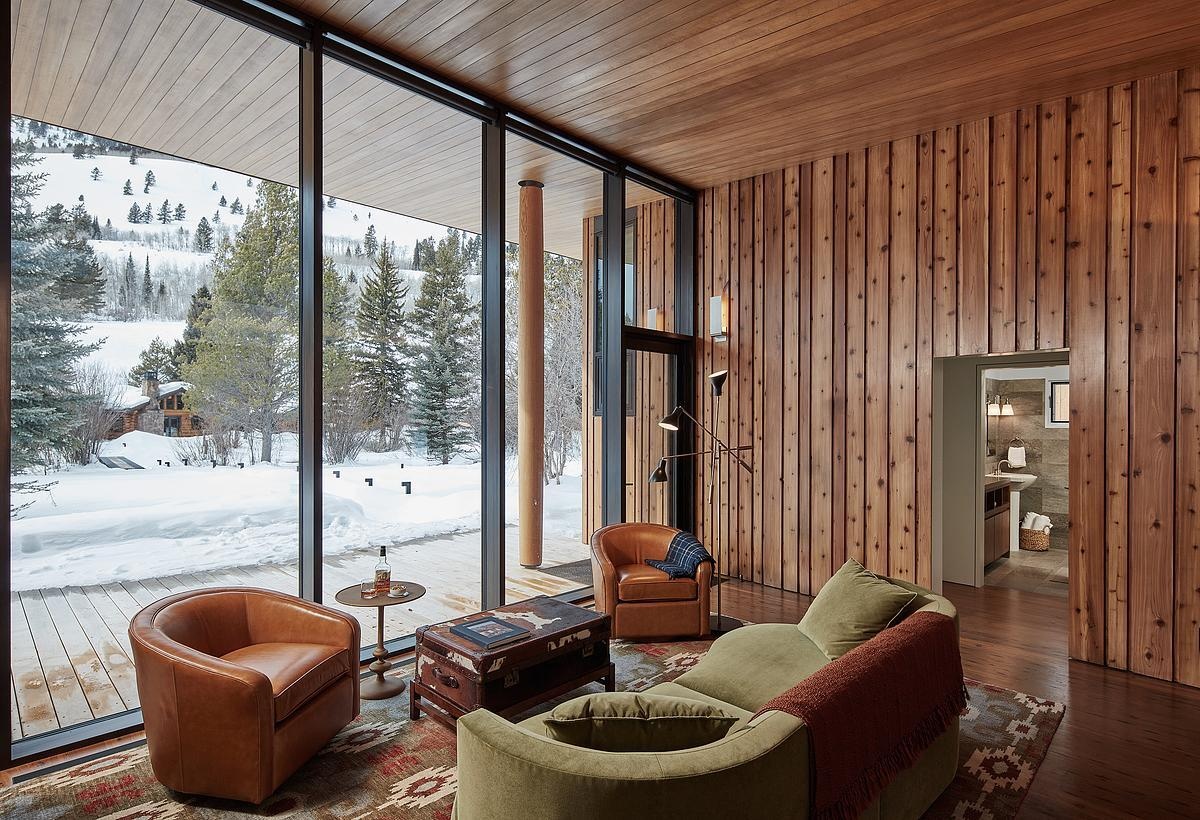 Inside the guest house, natural light, living room, and a small kitchen make the space both bright and practical.