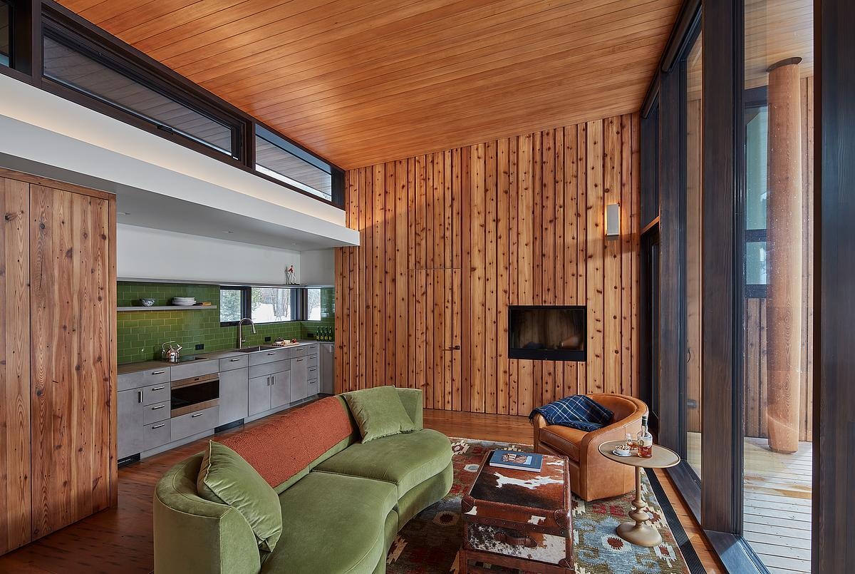 Inside the guest house, natural light, living room, and a small kitchen make the space both bright and practical.