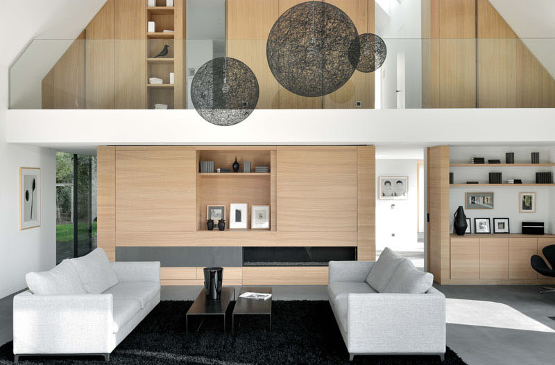 The living area now spans two storeys, opening up to the backyard with floor-to-ceiling windows.