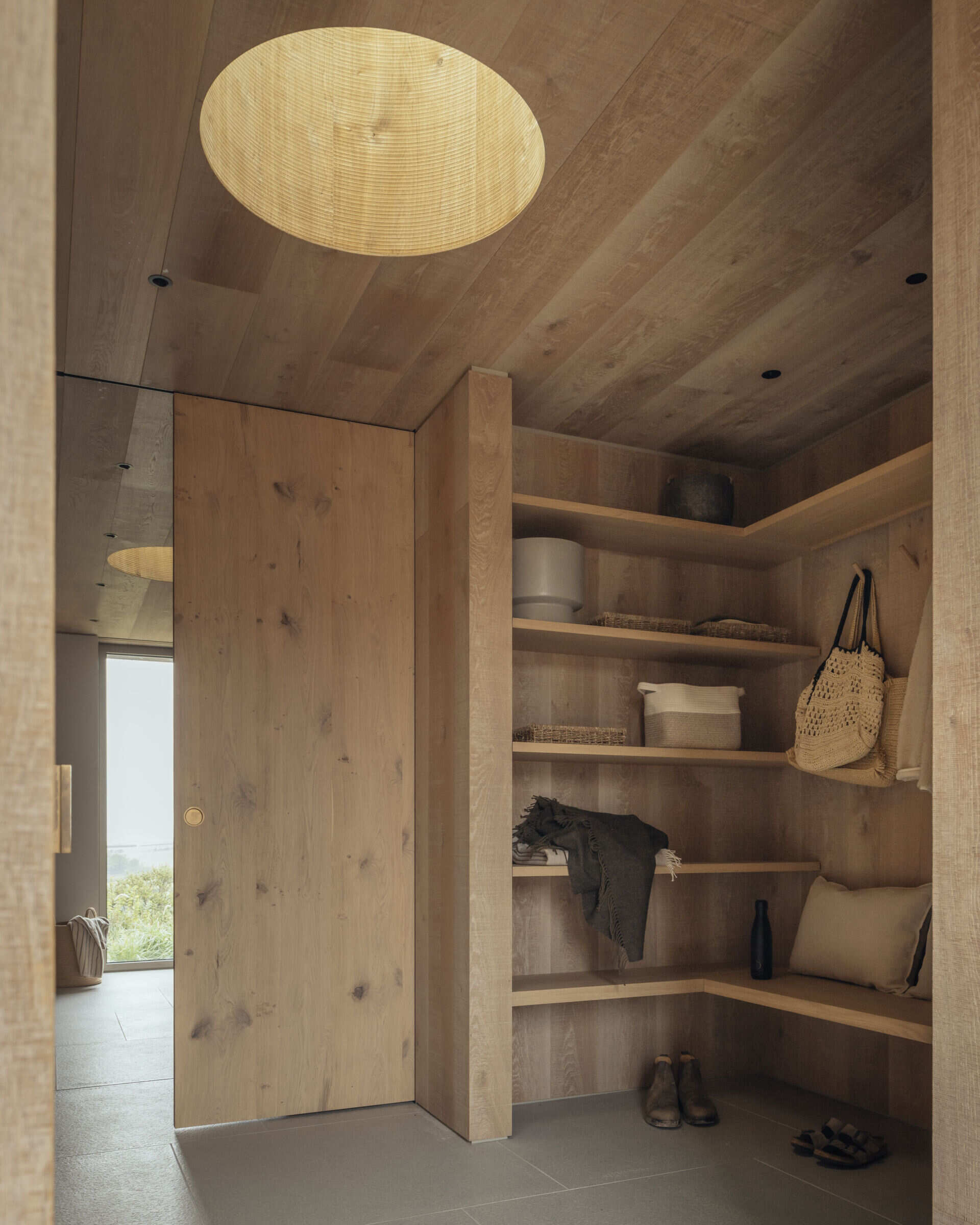 Essential for a family of surfers and cyclists, the mudroom and garage handle the mess of outdoor life. These functional spaces are deliberately separated from the main living areas, keeping the heart of the home serene.