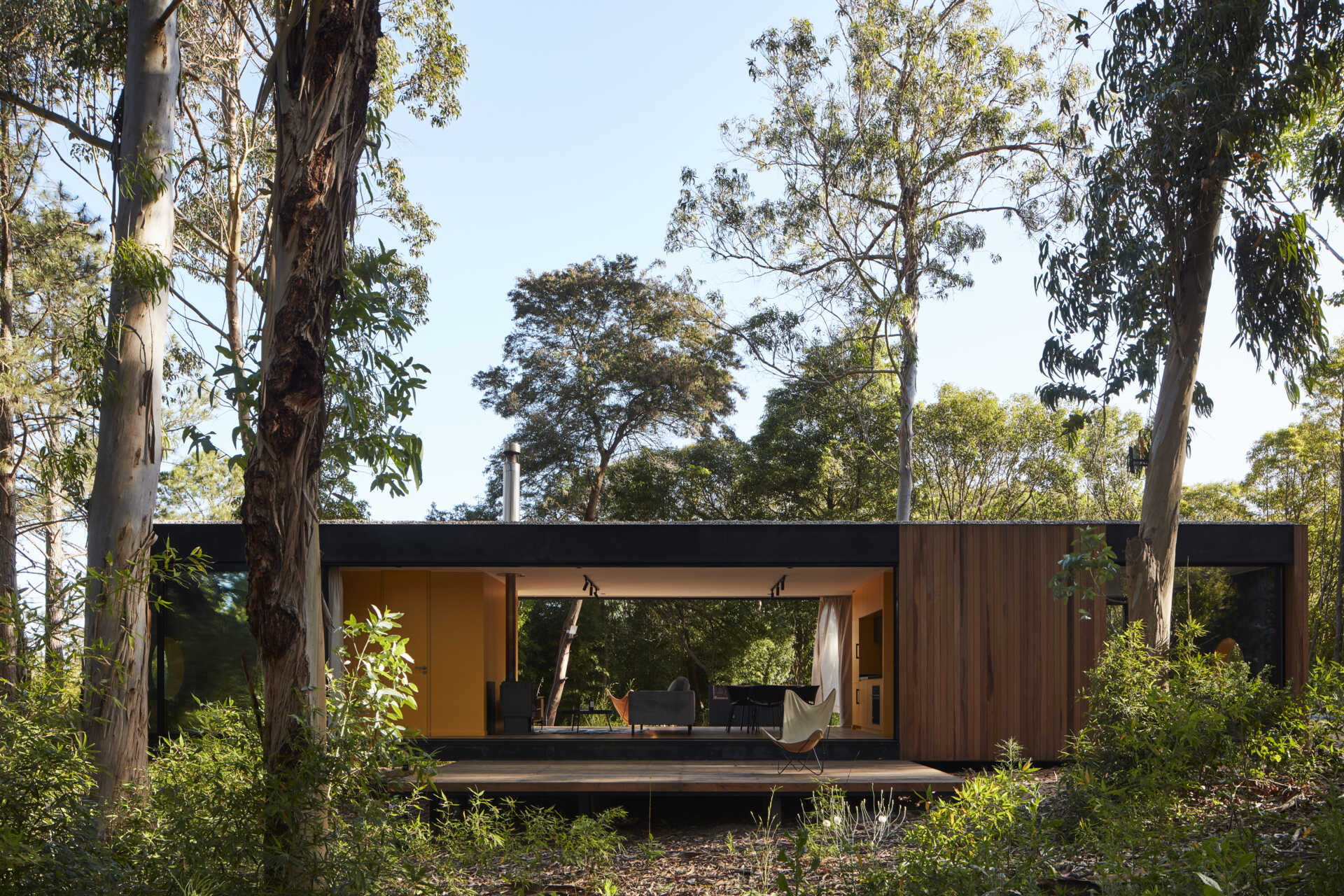 Drawing inspiration from mid-century single-family houses, this small forest home reinterprets classic ideas into a modern space where the inside and outside blend seamlessly.